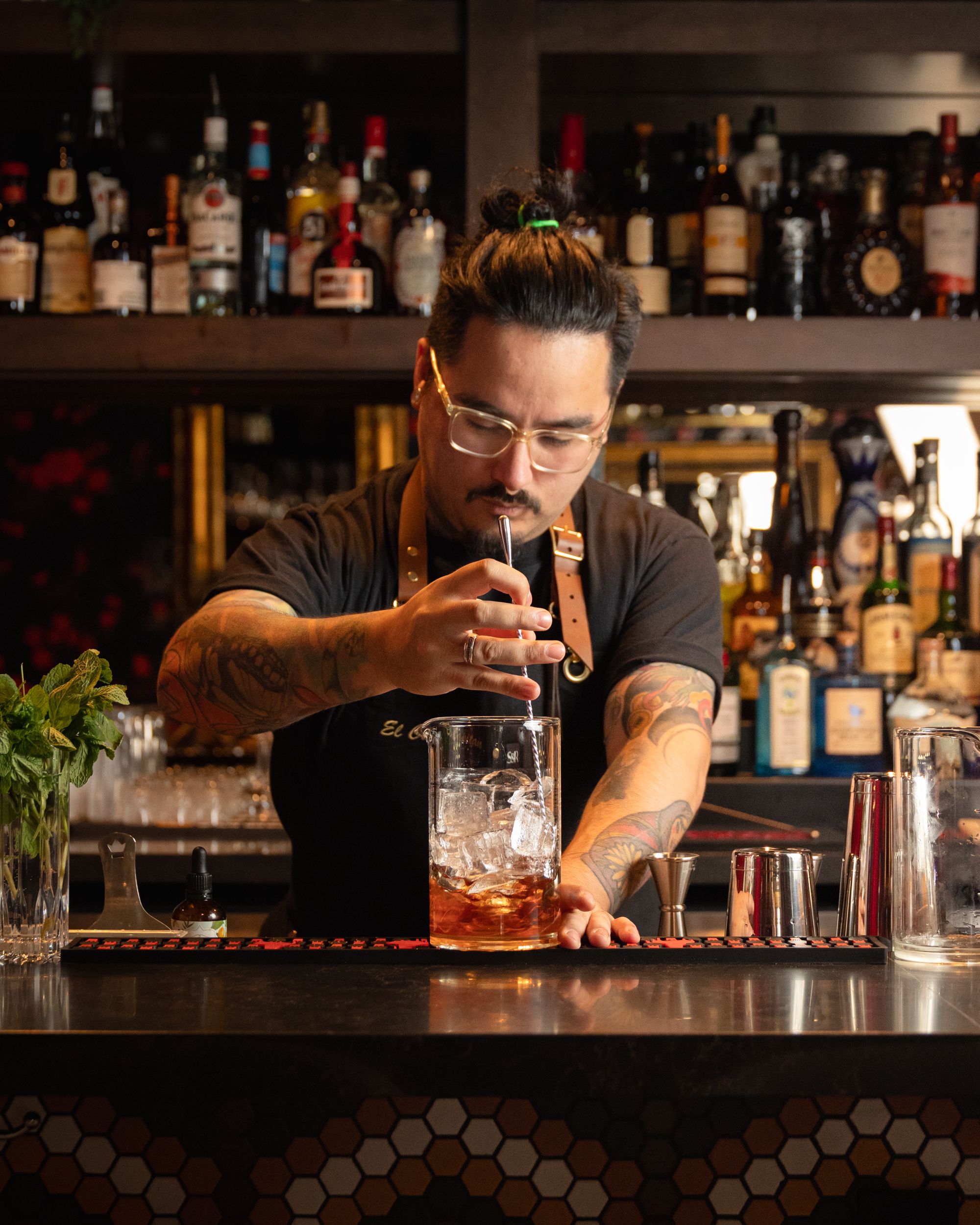 Bartender stirring a cocktail in a mixing glass at Terminal City Club bar
