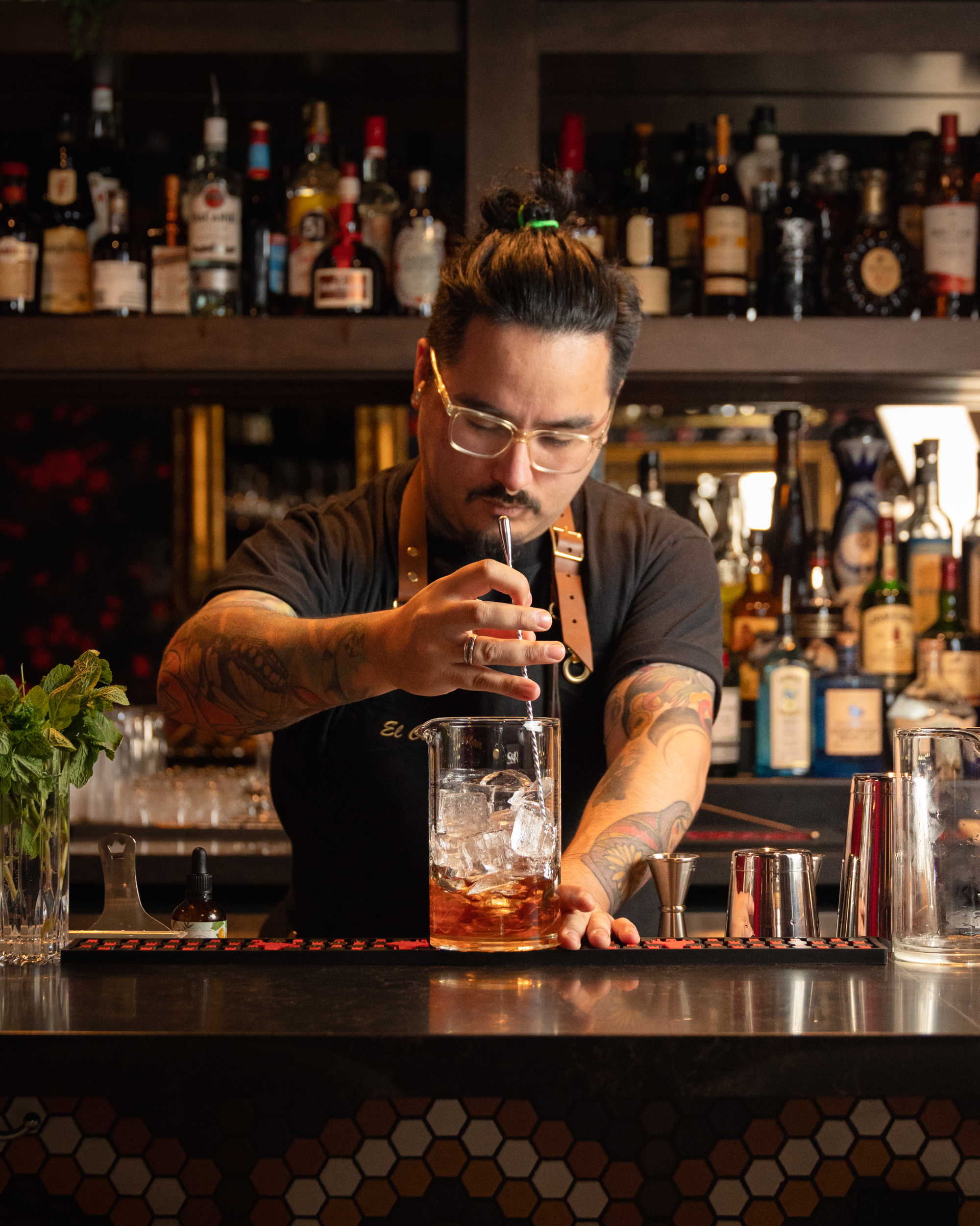 Bartender stirring a cocktail in a mixing glass at Terminal City Club bar