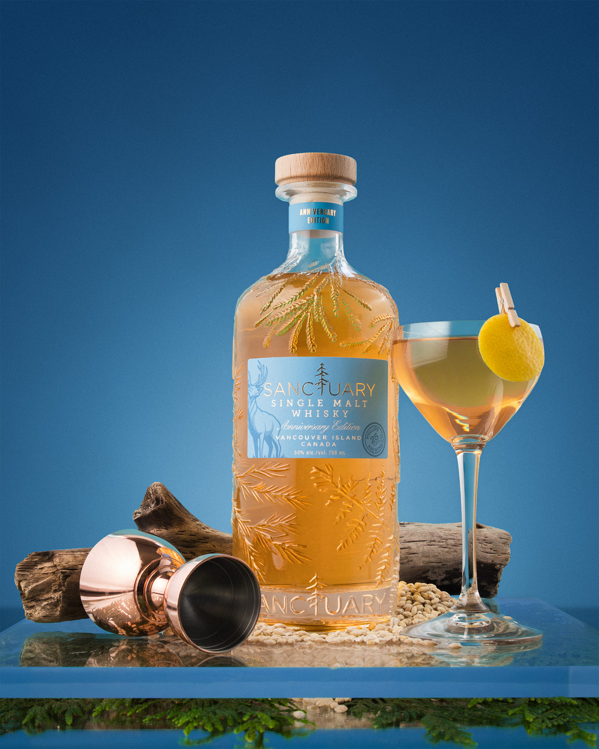 Sanctuary Anniversary Edition bottle with copper jigger and cocktail on a blue ground.
