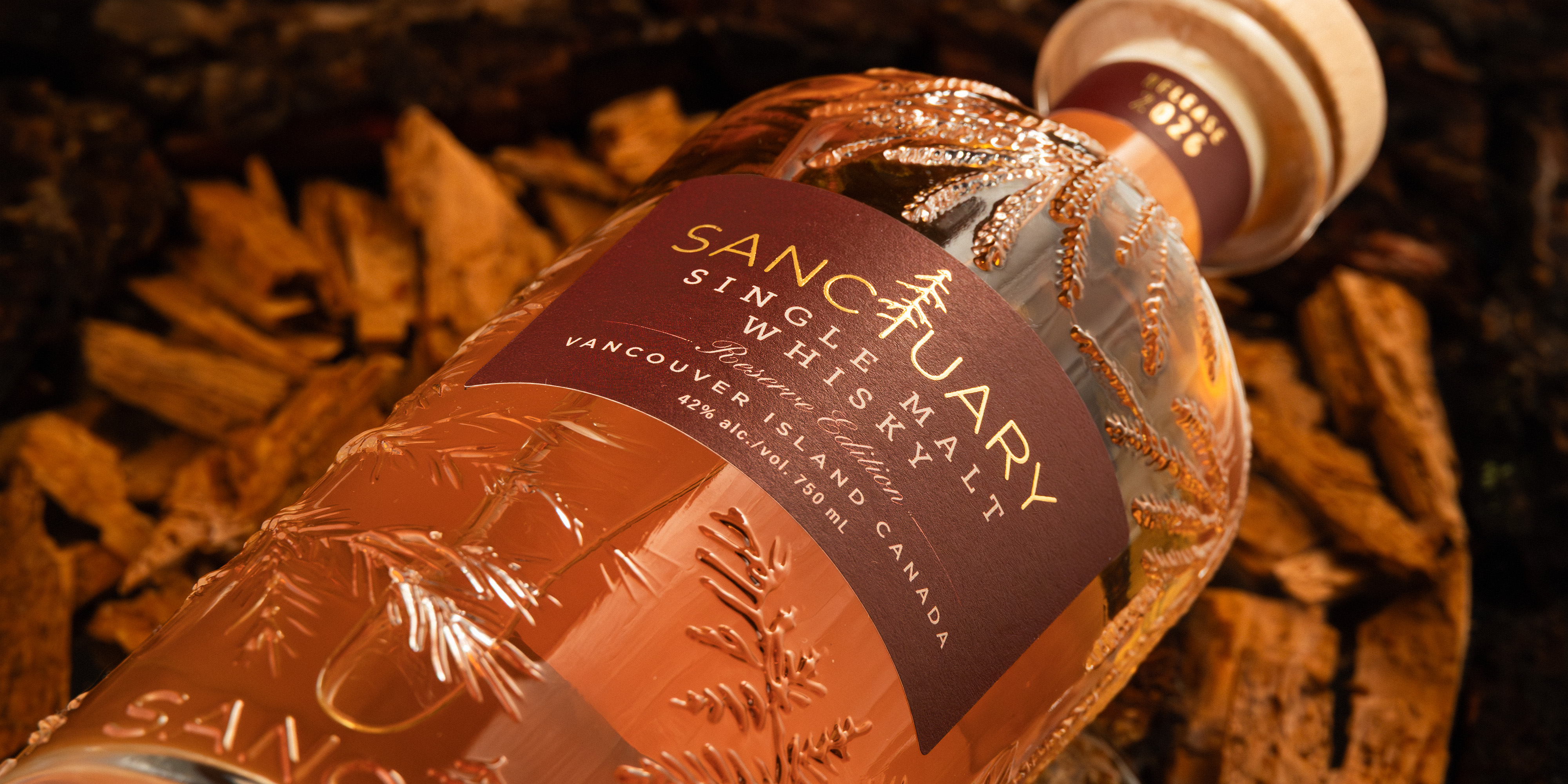 Sanctuary Reserve Edition label close-up on cedar bark in warm copper tones