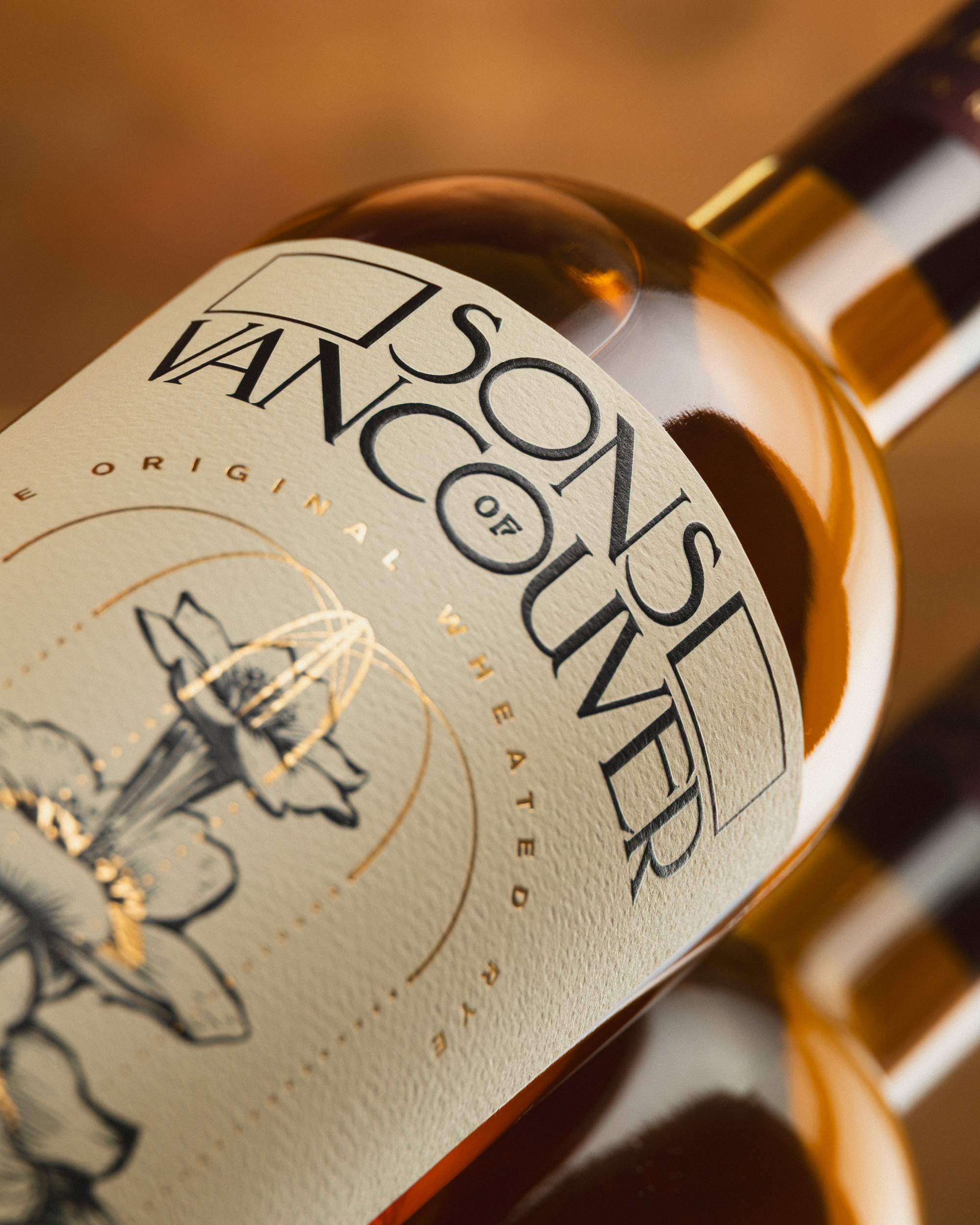 Sons of Vancouver Wheated Rye label close-up with gold botanical illustration.