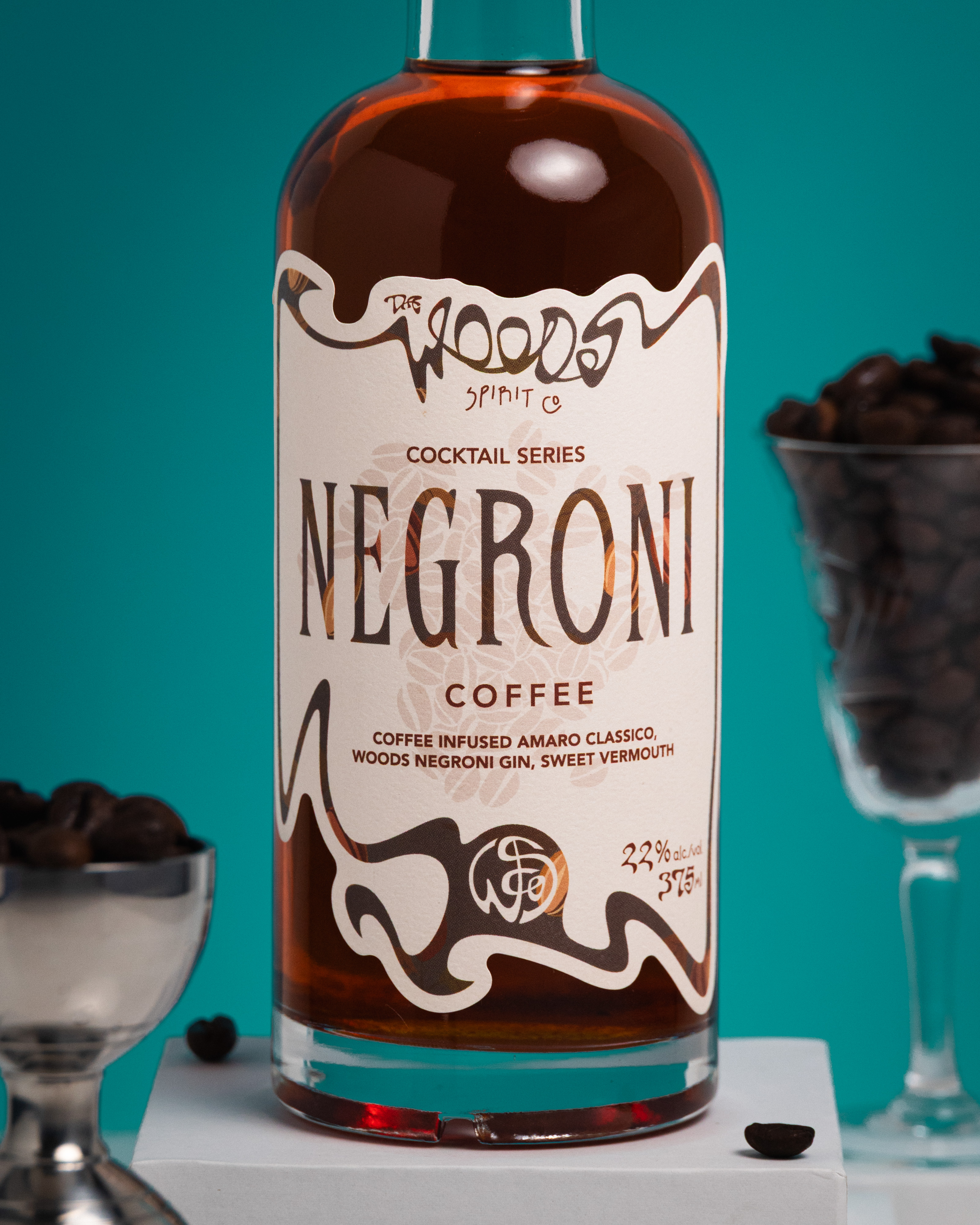 Wood Spirit Co Coffee Negroni bottle label close-up with coffee beans on a teal ground