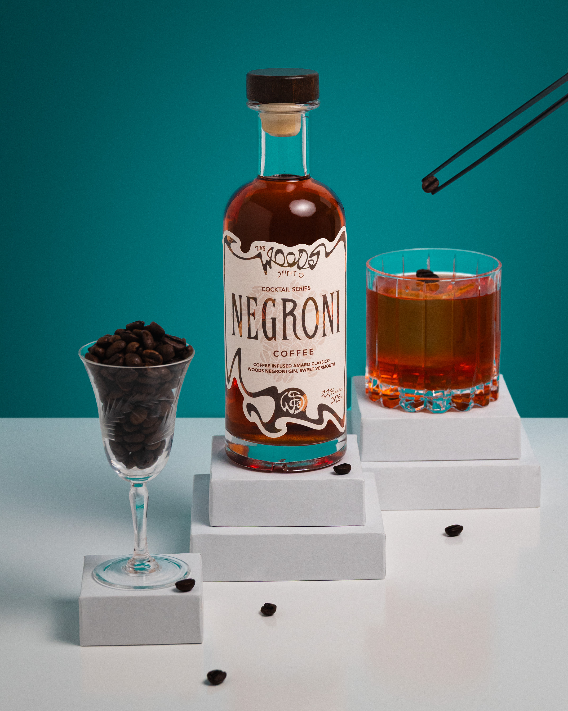 Wood Spirit Co Coffee Negroni bottle with served cocktail and coffee beans in coupe