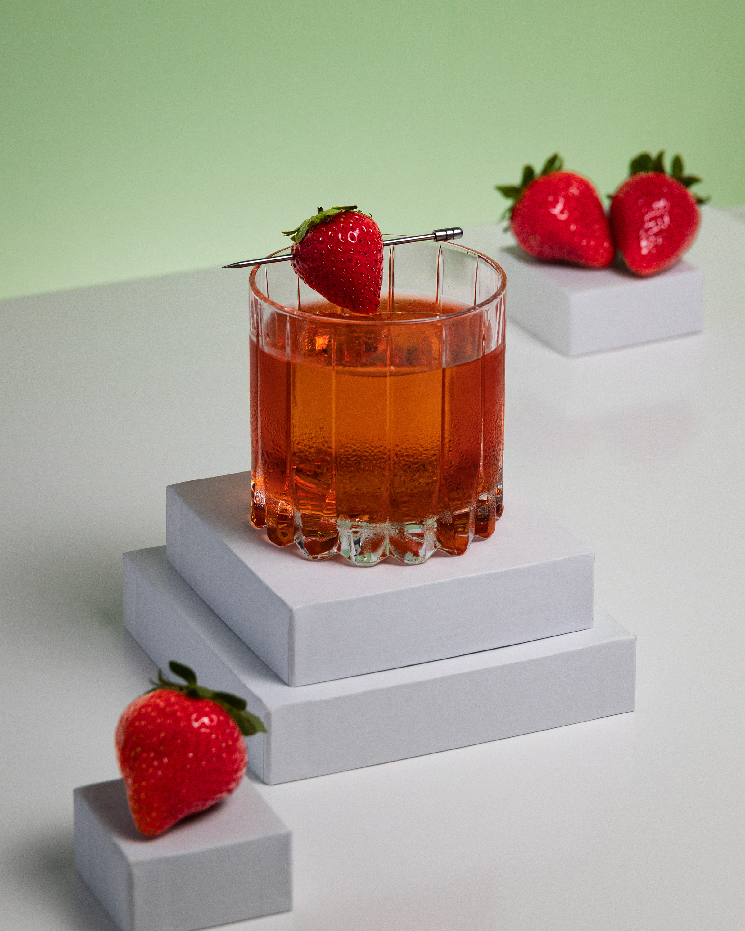 Wood Spirit Co strawberry cocktail in rocks glass with strawberry garnish on a pin